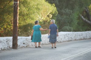 Two Yia Yias walk down the hill to the port.