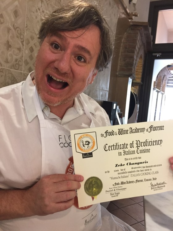 Zeke holding his course completion diploma for his Italian Cooking Class.